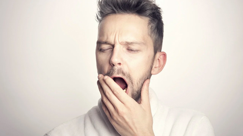 Man yawning while preparing for another New Orleans Pelicans season.