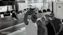 Bank robber Elias Macmillan, one of his accomplices, and a few customers/new friends pose for a picture at some point during the six months when the multi-millionaire thieves took up a residence in the bank due to slow NOPD response time.