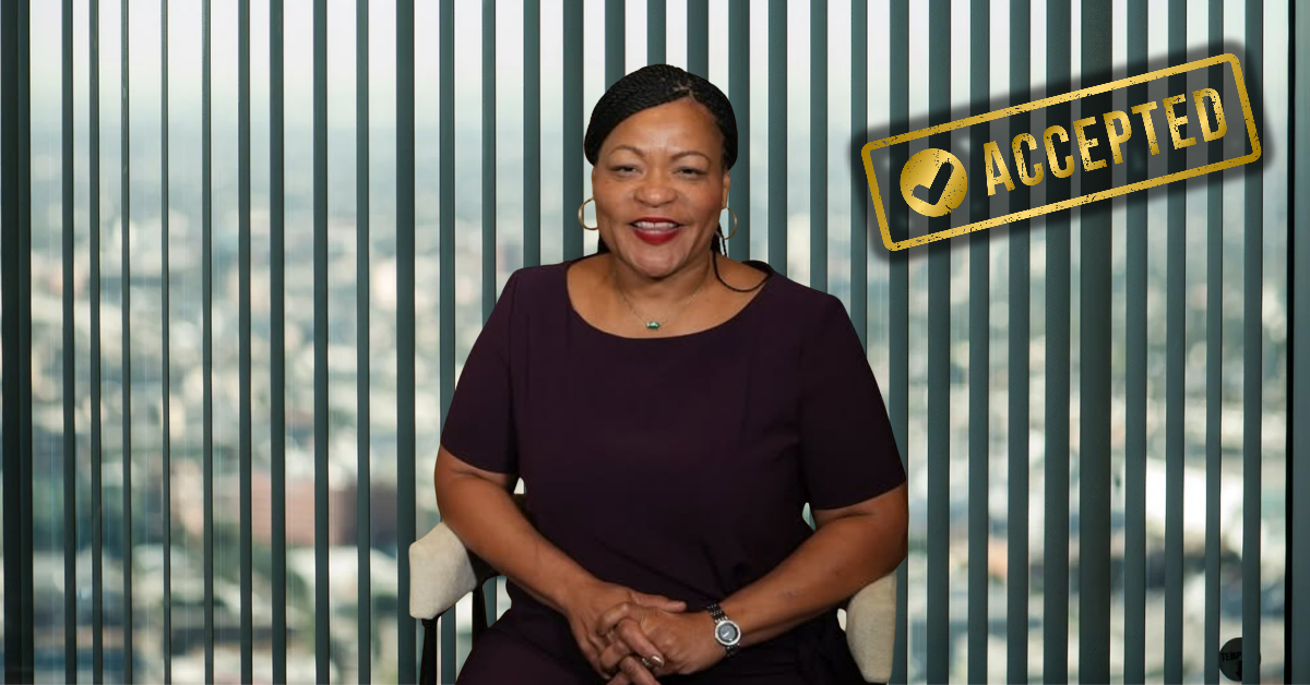 New Orleans Mayor LaToya Cantrell smiles in front of vertical blinds with an “ACCEPTED” stamp overlaid, following her admission into Louisiana’s political leadership program.