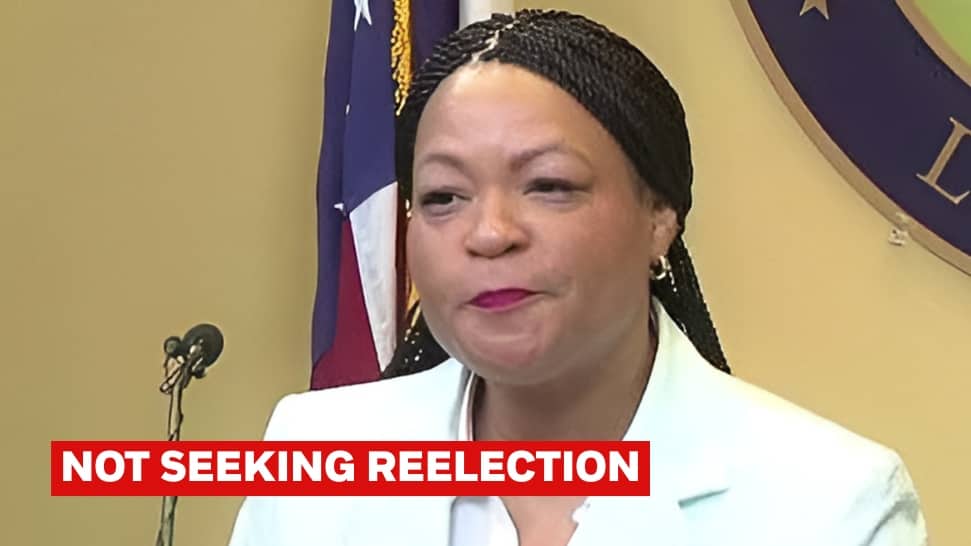 New Orleans Mayor LaToya Cantrell stands at a podium in front of the city seal and American flag, wearing a light blue blazer, with a red banner reading “Not Seeking Reelection” displayed across the image.