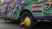 Mardi Gras float immobilized with a City of New Orleans wheel boot and an $850 fee notice.